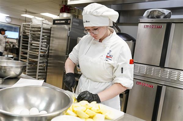 Culinary Arts and Science student working in kitchen 